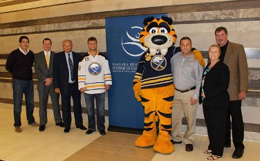 Group photo at the Niagara Health System with a Buffalo Sabres jersey and the team mascot