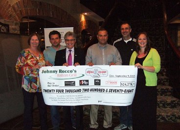 Group holding an oversized cheque for $24,278 presented at Johnny Rocco's Italian Grill
