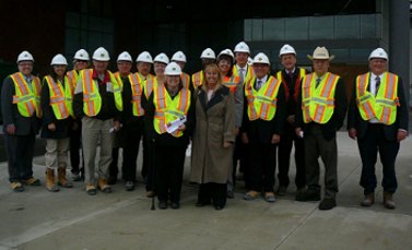 Construction site tour, a group in hard hats and high-visibility vests
