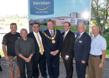 Group photo in front of a Meridian Centre banner, including the Mayor wearing the chain of office