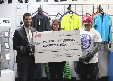 Team Harris presenting an oversized cheque to the Multiple Sclerosis Society
